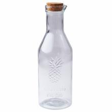 Sklenená fľaša s korkovým uzáverom a dizajnom ananásu.