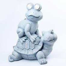 Sivé solárne korytnačky s žabou na chrbte.