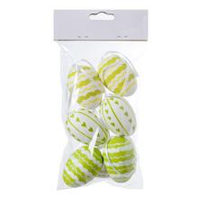 Sada plastových vajíčok bielej a zelenej farby s rôznymi vzormi.