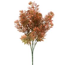 Umelé kvety s drobnými guličkami v zelenej a oranžovej farbe.