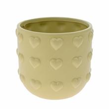 Zelený keramický obal v tvare srdiečka.