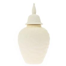 Dóza s poklopom z keramiky v krémovej farbe.