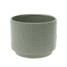 Zelený keramický obal s ornamentom.