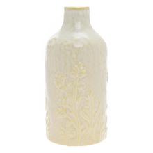 Úzka krémová váza s vzorom trávy.
