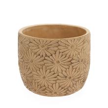 Žltý keramický obal s kvetinovým vzorom.