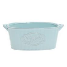 Modrý keramický obal na kvety oválneho tvaru.