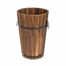 Drevený obal v tvare valca s čiernymi kovovými pásmi.