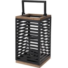 Kovový lampáš s dreveným vrchom a skleneným vnútrom.