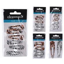 Sada štyroch pukačiek do vlasov v rôznych farbách a vzoroch.