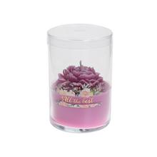 Voňavá sviečka v skle s ružovou farbou a kvetinovým dizajnom.