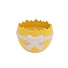 Žltý a biely porcelánový obal v tvare škrupiny.