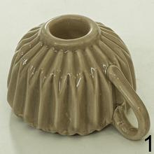 Svietnik v tvare šálky s opakovaným vzorom.