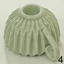 Svietnik v tvare šálky s opakovaným vzorom.