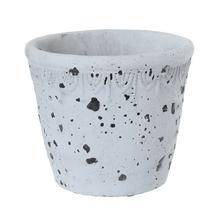 Cementový obal v antique šedej farbe s priemerom 15,5 cm a výškou 13,5 cm.