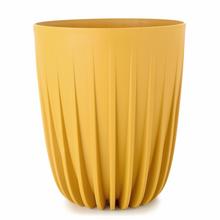 Okrúhly nízky obal MIRA v horčicovej farbe.