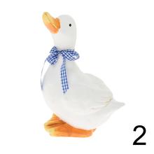 Biela keramická hus s modrou stuhou.