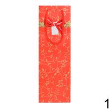 Darčeková taška na víno s zlatým ornamentom.