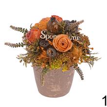 Smútočná väzba s ružovými kvetmi a zelenými listami.