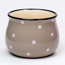 Obal na kvetináč s bodkami v krémovej farbe.