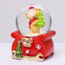 Tažítko s vianočnou postavičkou v snehovej guli.