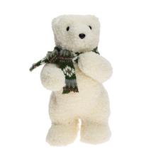 Biely stojaci medveď so zeleným šálom.