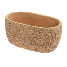 Žltý keramický obal s kvetinovým vzorom.