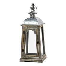 Šedobiely lampáš s kovovým vrchom.