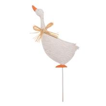 Zápich hus z kovu s oranžovým zobákom a mašľou.