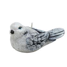 Veľká sivá figúrka vtáčika na sviečku.